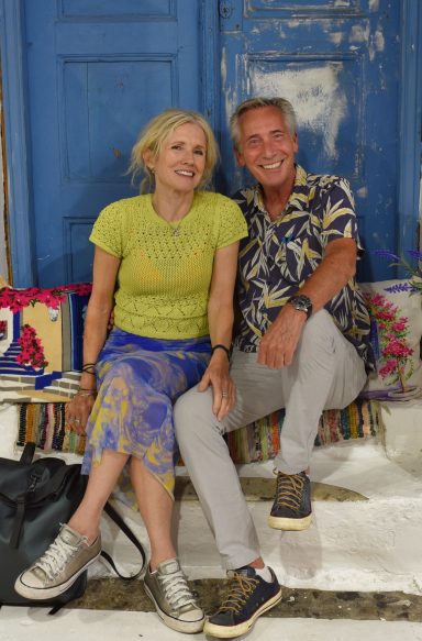 2025 Mature lifestyle modelling couple seated together in colourful travel setting