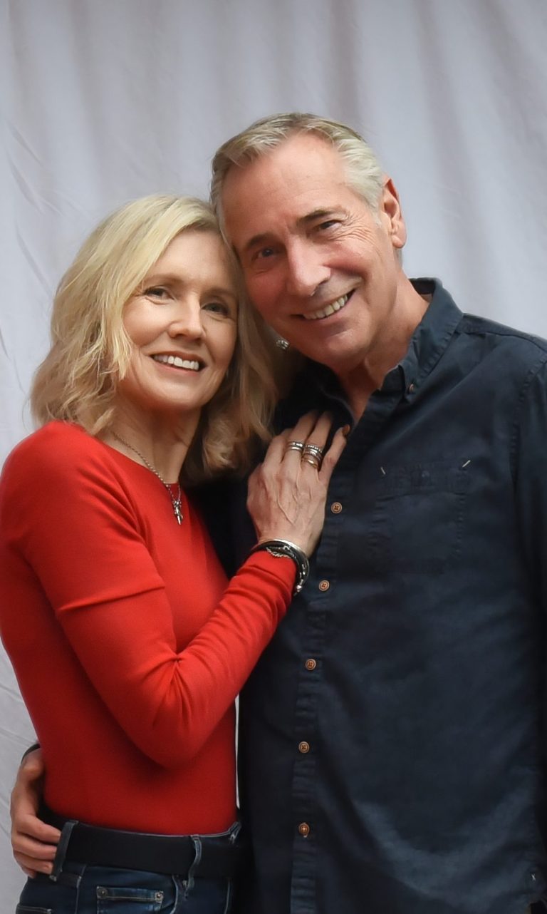 Mature couple models posing together in smart-casual outfits