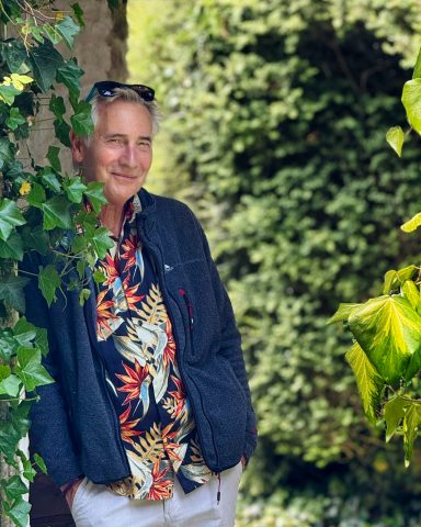 2025 Mature lifestyle model posing confidently outdoors in patterned shirt